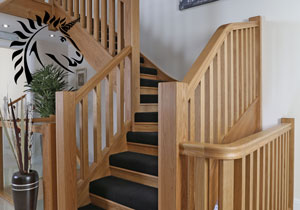 Bespoke Staircases in oak the manhattan staircase with half black carpet detail