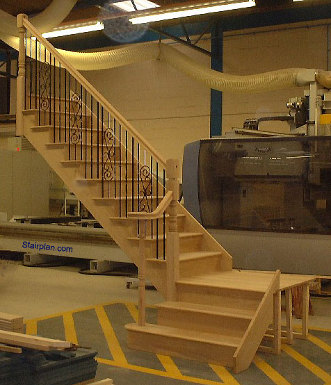 Oak Cut String staircase with a quarter landing and volute